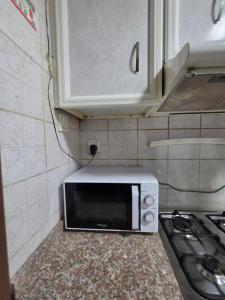 a microwave sitting on a counter in a kitchen at Ajman Studio Downtown B2OO7 in Ajman 
