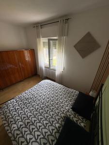 a bedroom with a bed in front of a window at Villa Magnolia Oliveti relax e privacy con panorama mozzafiato in Crosano +22 photos