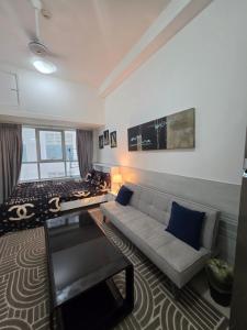a living room with a couch and a bed at Ajman Studio Downtown B2OO7 in Ajman 