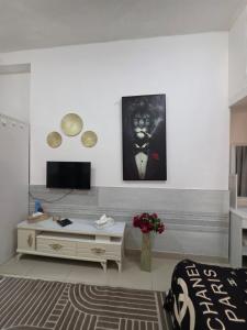 a living room with a tv and a table at Ajman Studio Downtown B2OO7 in Ajman 