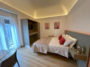 a bedroom with a bed with red pillows at Umbrella Street Home in Catania