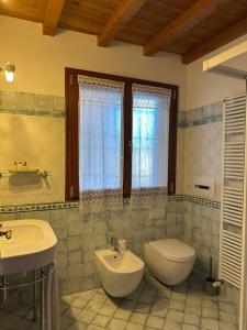 a bathroom with a sink and a toilet at B&B La Collina degli Ulivi in Zola Predosa