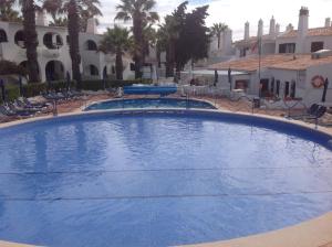 a large blue swimming pool in a resort at AD house on Carvoeiro in Carvoeiro