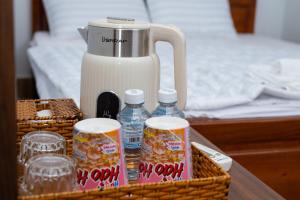 a basket with drinks and a jug of milk at Khách sạn Cozy Home 2 in Can Tho