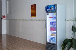 a refrigerator filled with drinks in a room at Khách sạn Cozy Home 2 in Can Tho