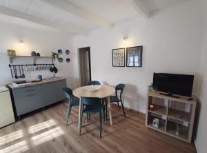 a kitchen and dining room with a table and chairs at Charme a Corniglio in Corniglio