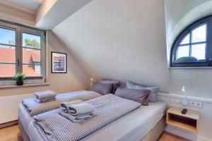 a bedroom with a bed with towels on it at Ferienhaus Boddenlust 24 Feriendorf Klein Stresow Rügen by ruyastay in Putbus