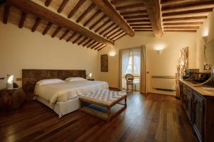 a large bedroom with a bed and a table at Capanna Suites in Montalcino +84 photos