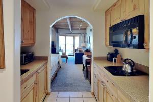 a room with a kitchen and a bedroom with a bed at Timberline Condominiums Studio Deluxe Unit 215 in Snowmass Village +13 photos