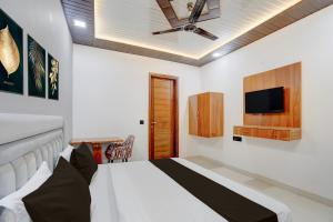 a bedroom with a bed and a tv on the wall at Townhouse Tuessday Suites Nearst Mr Bhatura Bala Sector 122 in Noida