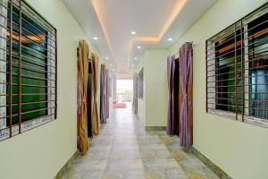 a corridor of a room with paintings on the walls at SPOT ON RISA PALACE in Bhutiāgāon