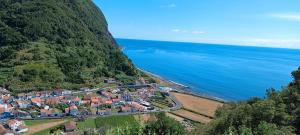 an aerial view of a small town next to the ocean at Casa do Faial da Terra in Faial da Terra