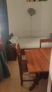 a room with a table and a bed and a table and chair at RAOOF HOTEL in Mahajanga