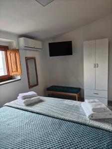 a bedroom with a bed with two towels on it at La casetta di Mercatello in Bagnoregio
