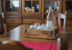a bottle of water and glasses on a table at Ferienwohnung in der Region Warstein in Warstein