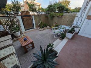 a patio with a table and some plants and a fence at Sunset House in Santa Marinella