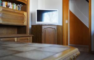 a living room with a television and a book shelf at Ferienwohnung in der Region Warstein in Warstein