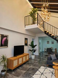 a living room with a tv and a staircase at Sapancamodern 2 in Sapanca