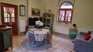a living room with a table with a vase of flowers on it at La Gloriette Riquewihr in Riquewihr