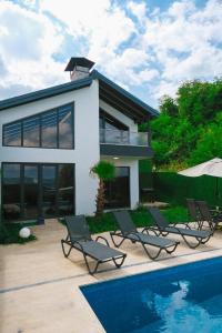 a house with chairs and a swimming pool in front of it at Sapancamodern 2 in Sapanca