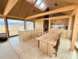 a large room with a wooden table and chairs at Storøya Lodge Lofoten in Vestvågøya