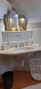 a bathroom with a sink and a mirror at Dimora Da Castello Lago Maggiore in Gravellona Toce