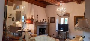 a living room with a fireplace and a tv at Dimora Da Castello Lago Maggiore in Gravellona Toce