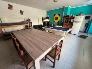 a kitchen with a wooden table and a kitchen with a pool table at Loft Salta in Bahía Blanca +8 photos