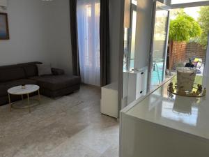 a living room with a couch and a table at Katy in Nice