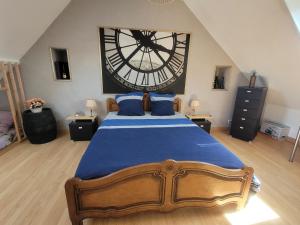 a bedroom with a large clock on the wall at La Maison Au 1894 bulles de bonheur et Spa in Avize