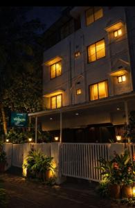 a tall building with lights in front of it at 88 villaggio Edappally in Edappally