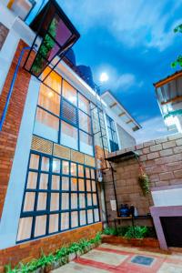 a house with large windows on the side of it at Jabulani Moshi in Msaranga