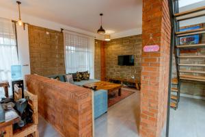a living room with a brick wall at Jabulani Moshi in Msaranga