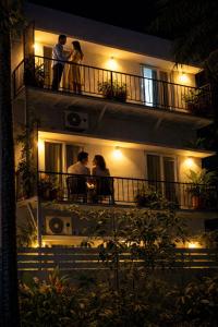 a group of people standing on a balcony at night at 88 villaggio Edappally in Edappally
