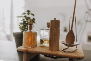 a wooden table with bottles and a bowl on it at BnB MAVIE & Whirlpool in Ingolstadt