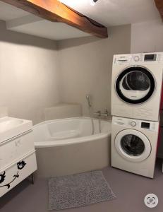 a bathroom with a washing machine and a washer at Rooms4Rent in Bottmingen