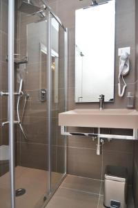 a bathroom with a sink and a shower at Bed In Centro in Naples