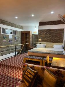 a bedroom with a large bed and a brick wall at Jabulani Private Villas in Arusha +36 photos