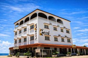 a building on the beach in front of the ocean at RAOOF HOTEL in Mahajanga