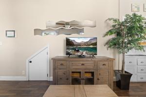 a room with a wooden cabinet and a potted tree at Marvelous Midtown Stay with a Modern Twist in Sacramento