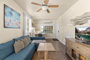 a living room with a blue couch and a tv at Marvelous Midtown Stay with a Modern Twist in Sacramento