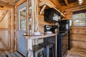 a kitchen with a counter and a refrigerator at Creekside Hideout in Cosby