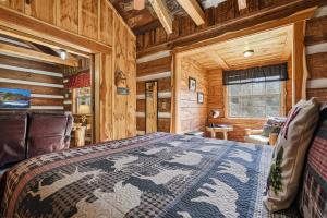 a bedroom with a bed in a wooden cabin at Creekside Hideout in Cosby