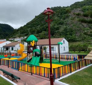 a play park with a playground with a slide at Casa do Faial da Terra in Faial da Terra