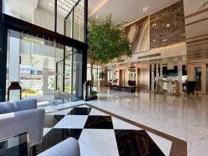 a lobby with a black and white tiled floor at The Iconic in Pattaya