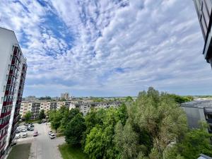 a view of a city street with trees and buildings at GIN Apartment No 82 SELF CHECK-IN in Mažeikiai +10 photos