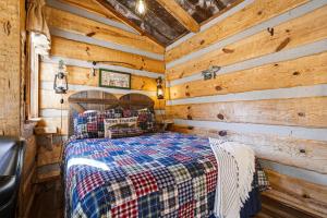 a bedroom with a bed in a wooden cabin at Creekside Treehouse in Cosby