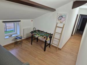 a room with a table and a ladder in a room at Le Fond du Village in Solre-Saint-Géry