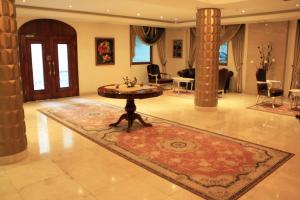 a large living room with a table and a rug at Atropat Old City Hotel in Baku