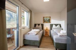 a room with two beds and a window at Ferienwohnungen Roko in Schlitters